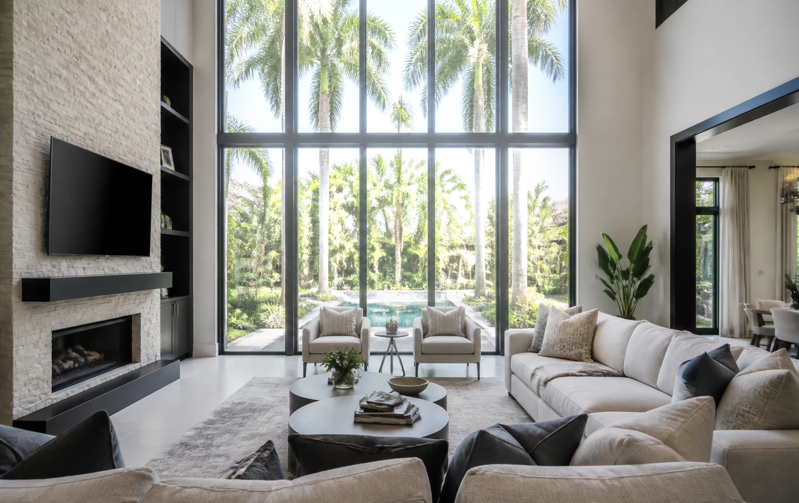 Bright sunlight blasting through untreated living-room windows with heavy glare on the floor and furniture