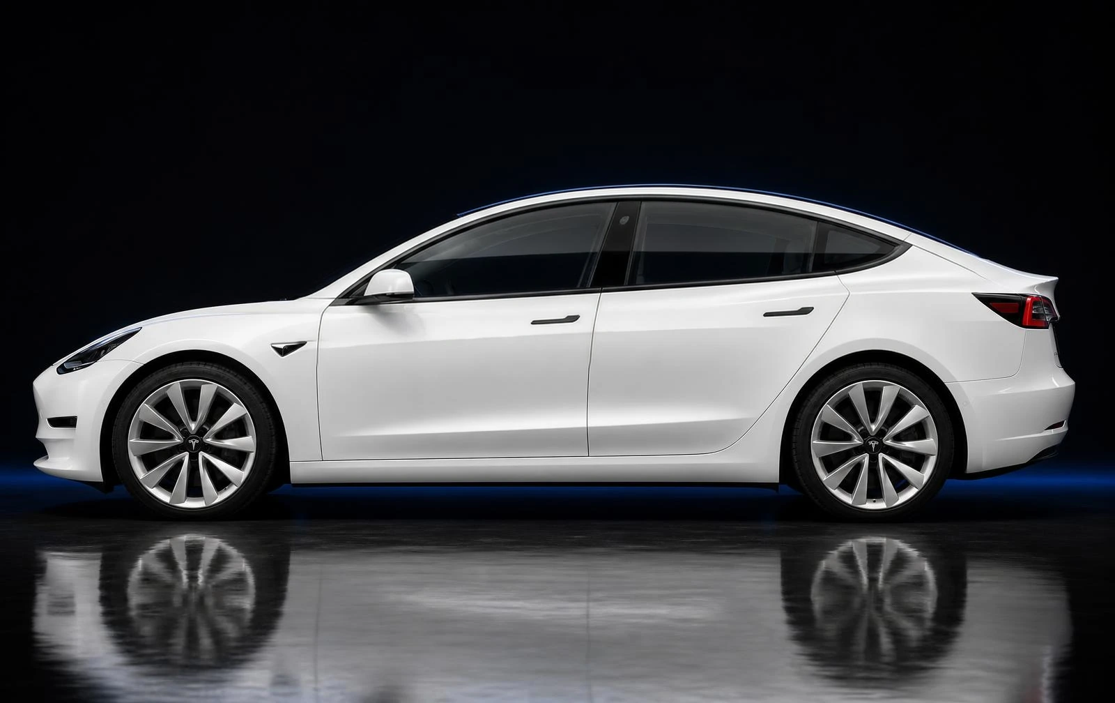 The same Tesla Model 3, same angle, with the identical window trim and mirror cap finished in satin black