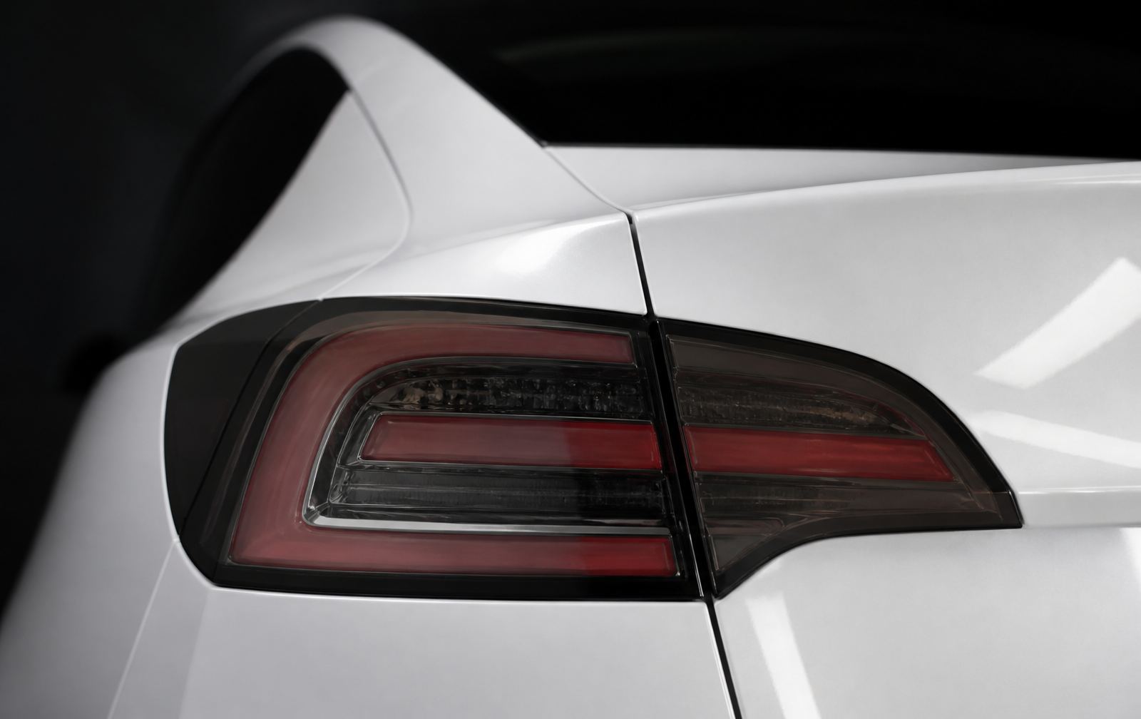 The identical taillight with uniform neutral smoke film applied only to the lens, with red elements clearly visible